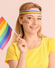 Woman with LGBT flag on color background